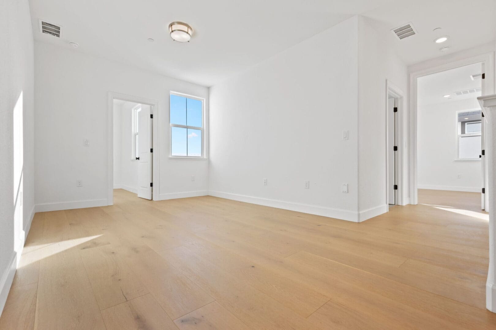 Spacious empty room with wooden floor.