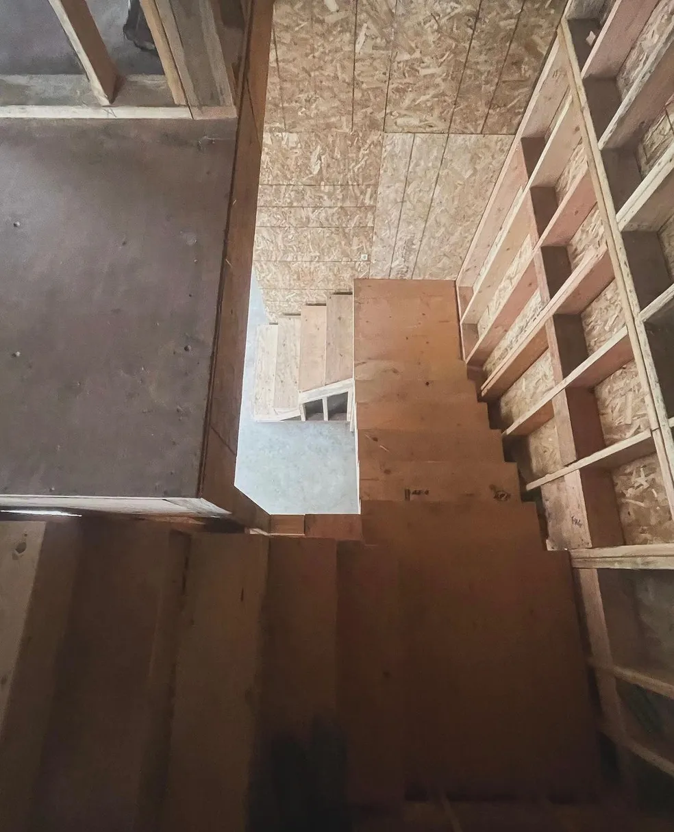 Unfinished wooden staircase under construction.