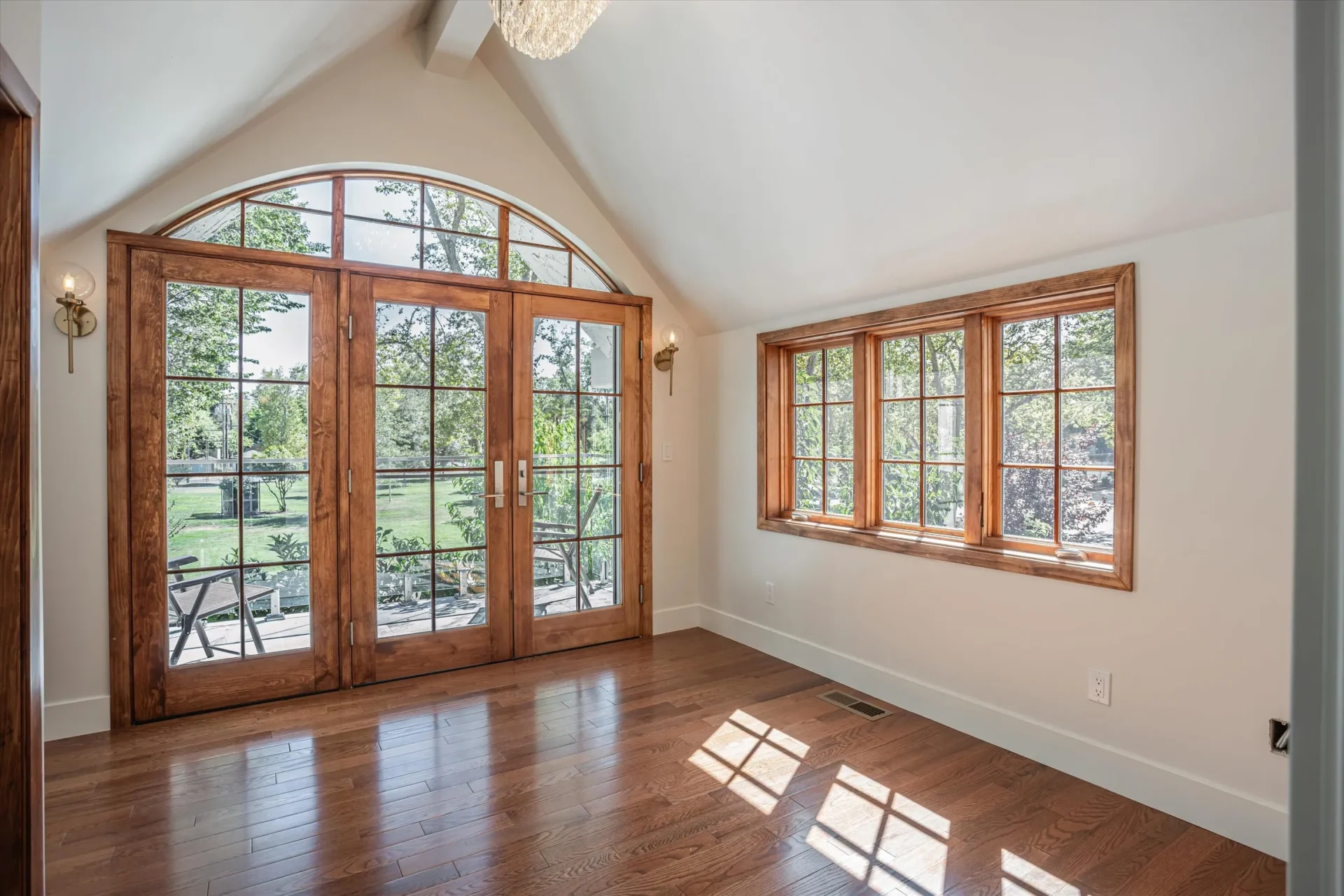 Bright room with wooden doors and windows.