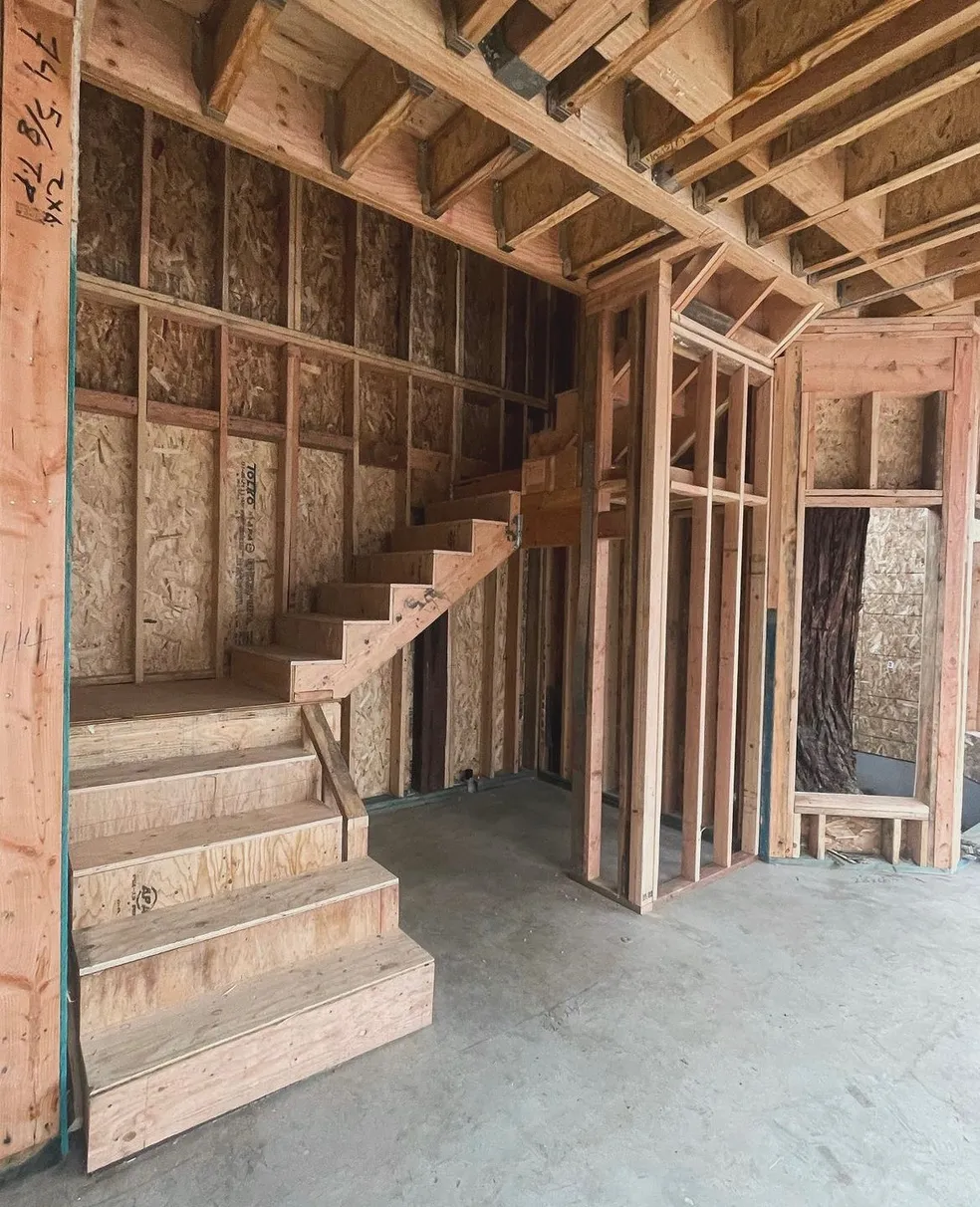 Unfinished wooden staircase in construction site.