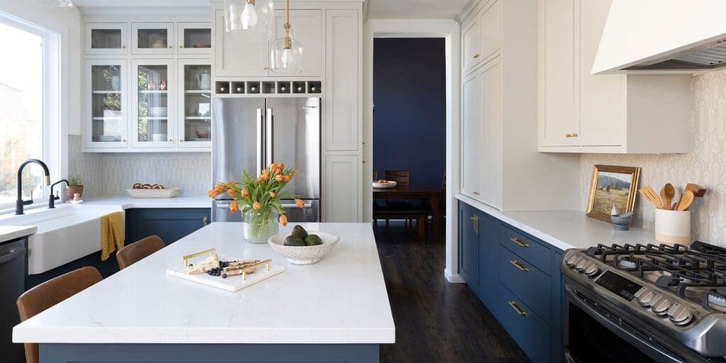 Modern kitchen with island and stainless appliances.