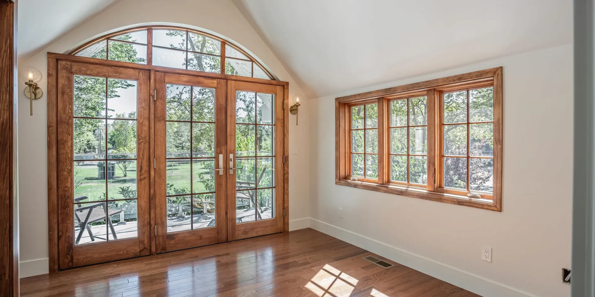 Bright room with wooden doors and windows.